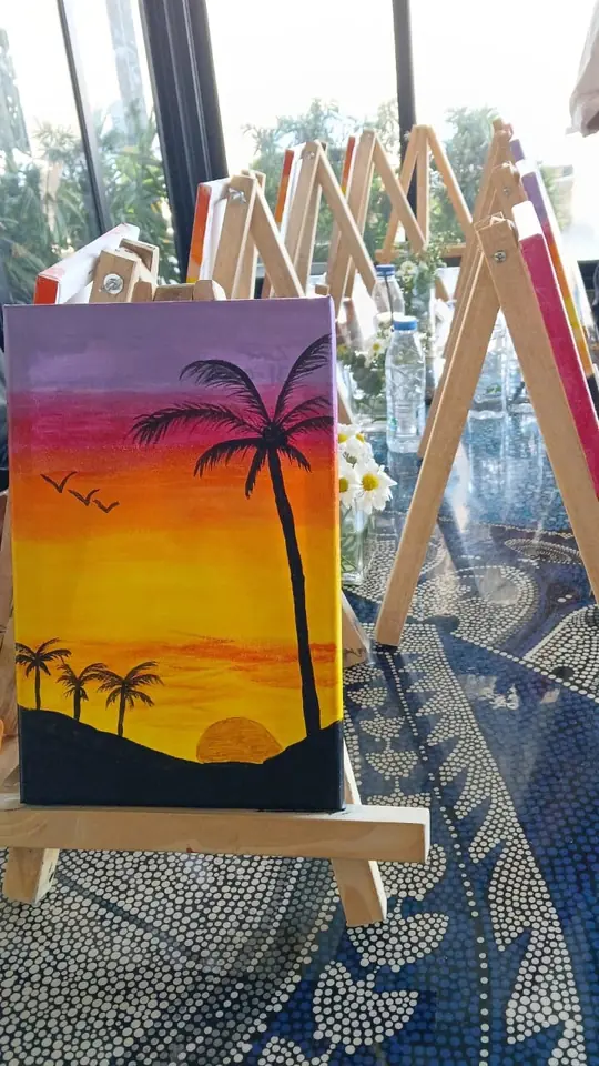 Atardecer con palmeras pintado en un lienzo